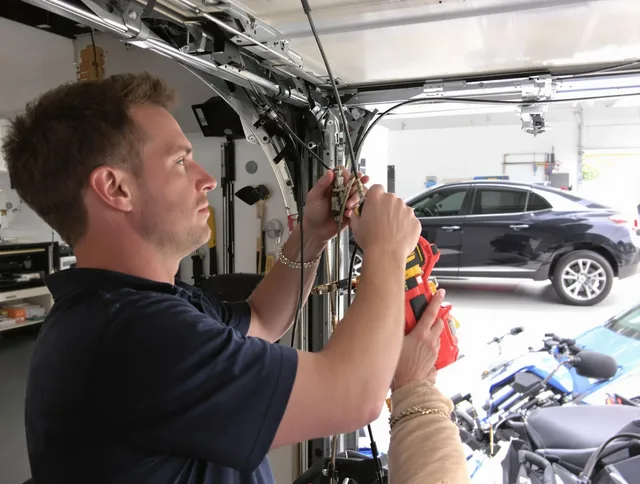 Orange Garage Door Repair safety certified technician performing cable replacement in Orange